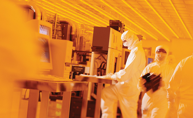 People working in protective suits in a cleanroom