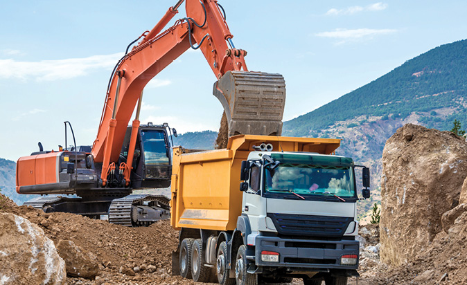 Excavator and truck construction site