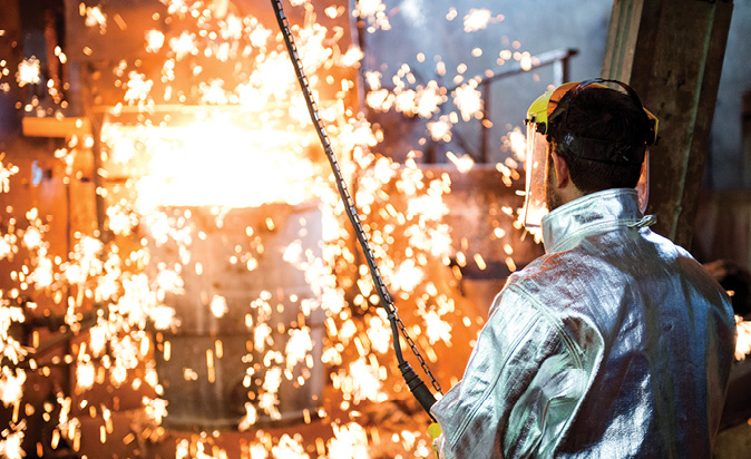 Workers in protective clothing in a hot working environment
