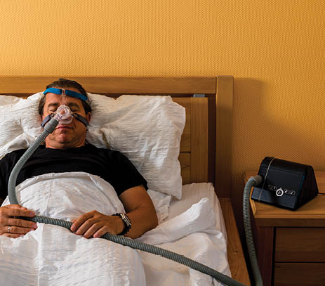Man wearing a CPAP machine.